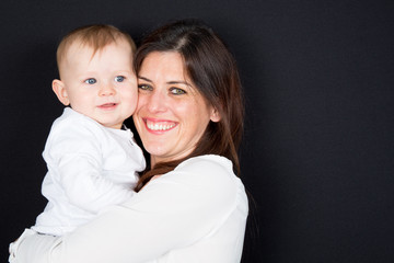 Happy smiling mother and son embracing
