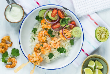 Tandoori prawn skewers with rice and chopped salad - top view