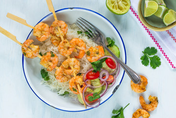 Tandoori prawn skewers with rice and chopped salad - top view