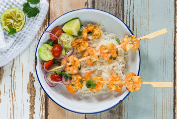 Tandoori prawn skewers with rice and chopped salad - top view