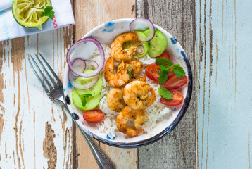 Tandoori prawns with rice and chopped salad - top view