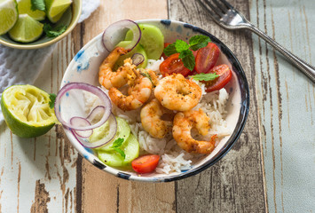 Tandoori prawns with rice and chopped salad - high angle view
