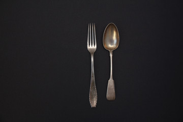 vintage old fork and spoon. silver. dark background