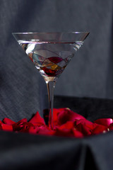 Cocktail glass and rose's petals