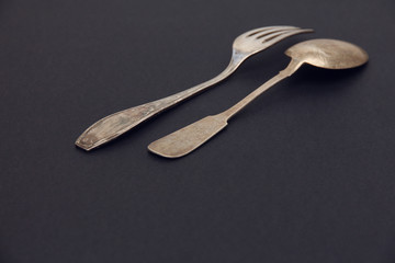 vintage old fork and spoon. silver. dark background