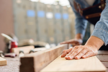 Carpenter working on woodworking machines in carpentry shop. woman works in a carpentry shop.