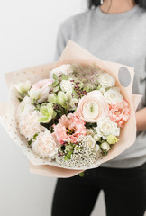 beautiful luxury bouquet of mixed flowers in woman hand. the work of the florist at a flower shop. Vertical photo