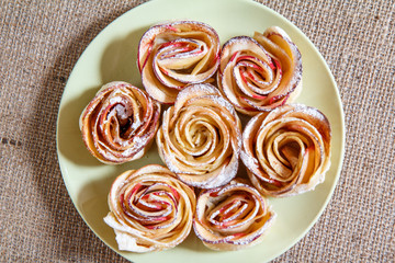 Homemade biscuits with apples in the form of rose on plate
