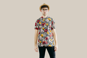 Young stylish man posing at white wall