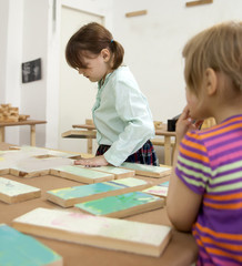 Girls   collecting   wooden puzzle