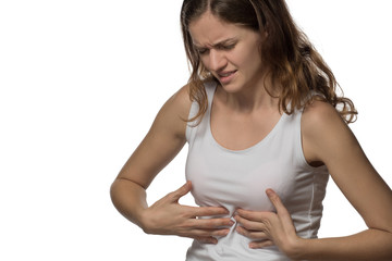 Pain and cramps in the abdomen of a beautiful girl on a white background
