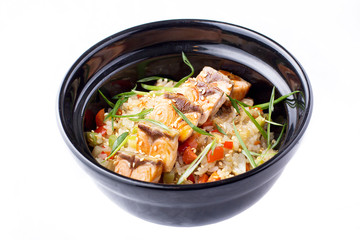 Japanese food. Rice with vegetables and fried salmon in a black bowl. Japanese food dish isolated on white background.