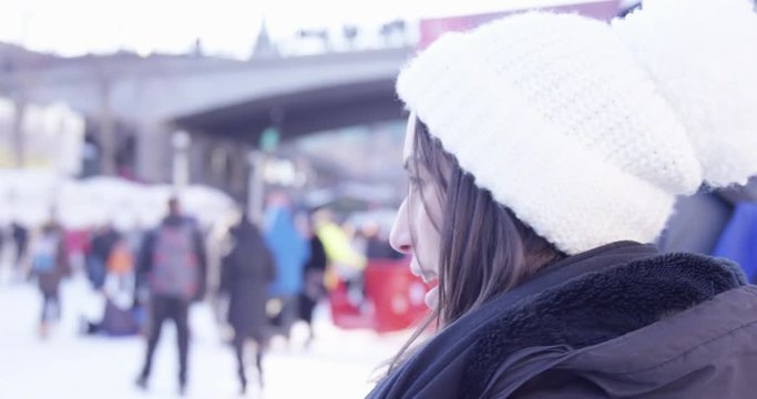 Woman on Rideau Canal in Ottawa during winter talks and points