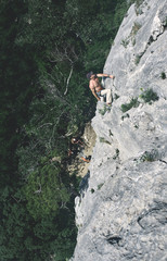 Fototapeta na wymiar man rock climber climbs on the cliff