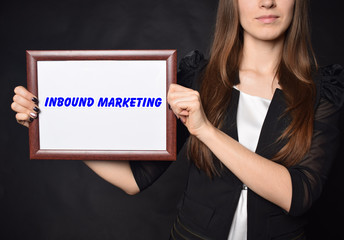 In the hands of a businessman a frame with the inscription:INBOUND MARKETING