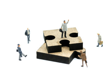 Miniature people : businessman standing with jigsaw puzzle pieces ,Business vision concept.