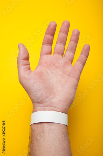 Download "Blank mockup bracelet on hand, isolated on yellow background. Concert paper wristband." Stock ...