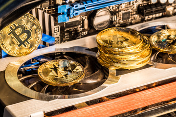 Shiny physical bitcoins and record-keeping equipment. Mining farm.