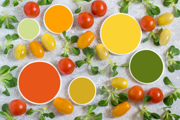 Multicolored cherry tomatoes, lamb salad and color samples