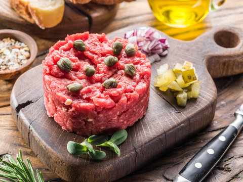 Steak tartare served with capers, pickled cucumbers and chopped onion.