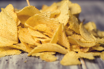 A lot of chips lie on the table, not a healthy diet and harmful food