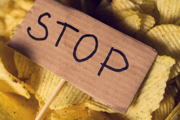 scattered chips and a sign with a stop sign