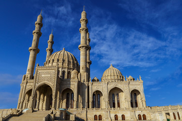 Fototapeta na wymiar Mosque against a blue sky with clouds