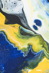 close up of abstract texture with yellow and blue oil paint