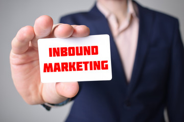 Businessman shows business card with the inscription:INBOUND MARKETING