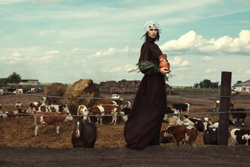 Amish styled model is posing with animals