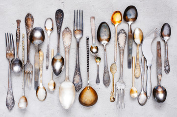 Vintage silverware lying on the grey table