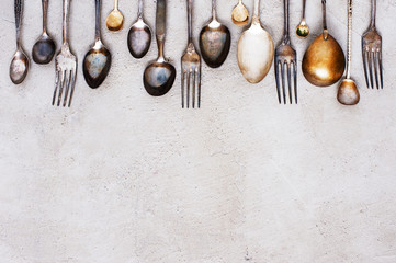 Background with vintage silverware on the grey table