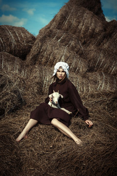 Amish styled model is posing with animals