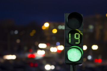 traffic light green signal on the night on the back lights of cars. Night road.