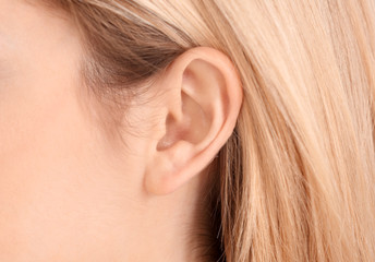 Young woman, closeup. Hearing problem
