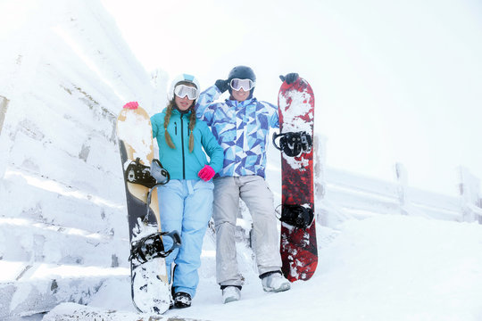 Young couple at snowy resort. Winter vacation