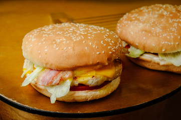 Chiken burger with egg and bacon on the gutar