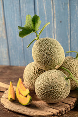 Close up cantaloupe melons on wooden table