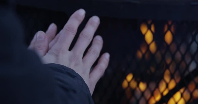 Womans trying to warm up her hands outdoors in winter