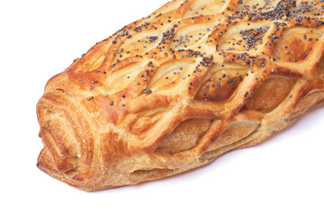 Baked bun with puff pastry sprinkled with poppy seeds isolated on white background.