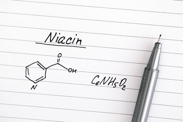 Chemical formula of Niacin on lined paper with black pen.