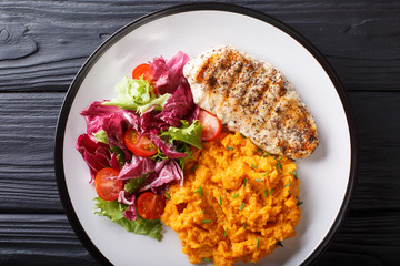 Healthy food: grilled chicken fillet with mashed potatoes and fresh salad closeup. horizontal top view