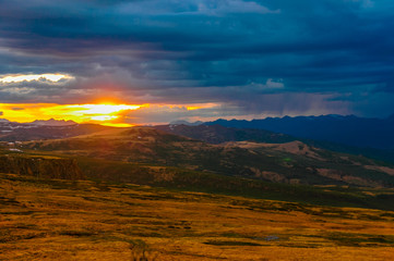 Naklejka na ściany i meble Mountain landscape with clouds. Mountain valley. The Altai mountains. Dramatic sunset in the mountains. Travel adventure vacation background