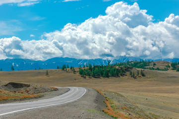 Mountain landscape with clouds. Mountain valley road. The Altai mountains. Travel adventure vacation background