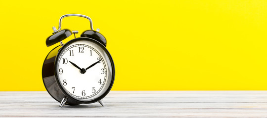 alarm clock wooden plank colored background