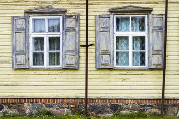 Fototapeta na wymiar Old yellow wall with some windows