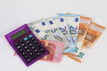 different euros with a calculator are lying in the studio