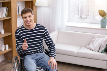 Being satisfied. Handsome young man expressing positivity while spending weekends at home