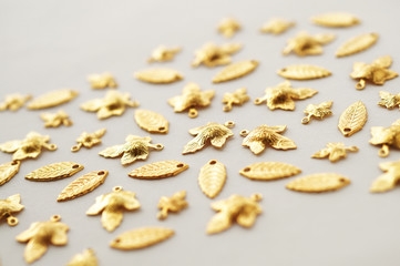 Plenty of gold shining metal leaves. Jewelry findings