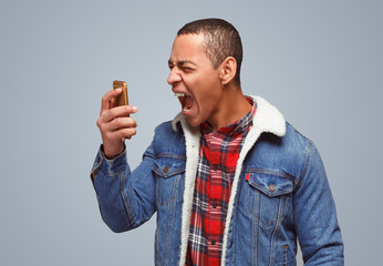 Screaming man with phone in rage
